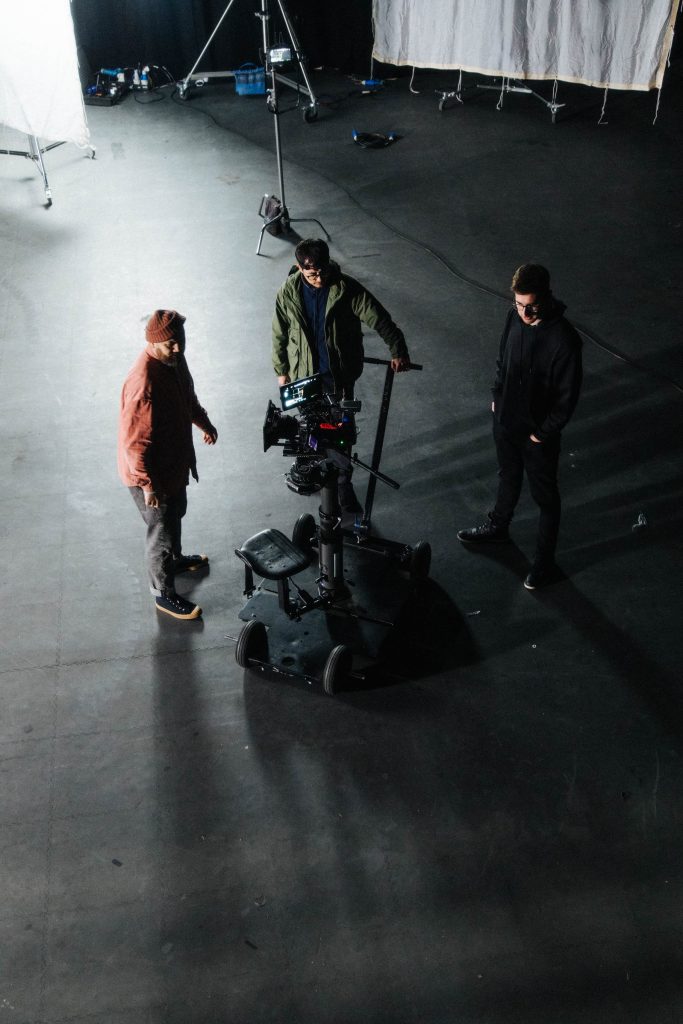 The Sonder Studios Professional Video Production team surrounding a camera on a trolley.